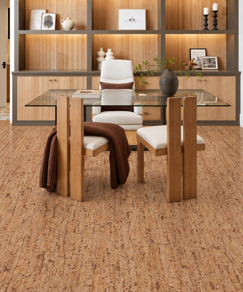 Woodflow medium-brown floating cork flooring complements a compact study with glass table and illuminated shelving.