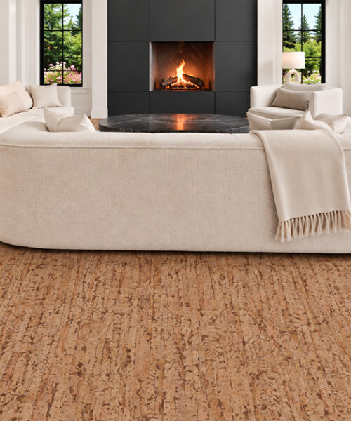 Medium-brown Woodflow cork flooring with organic linear grain grounds a bright dining room with cream chairs.